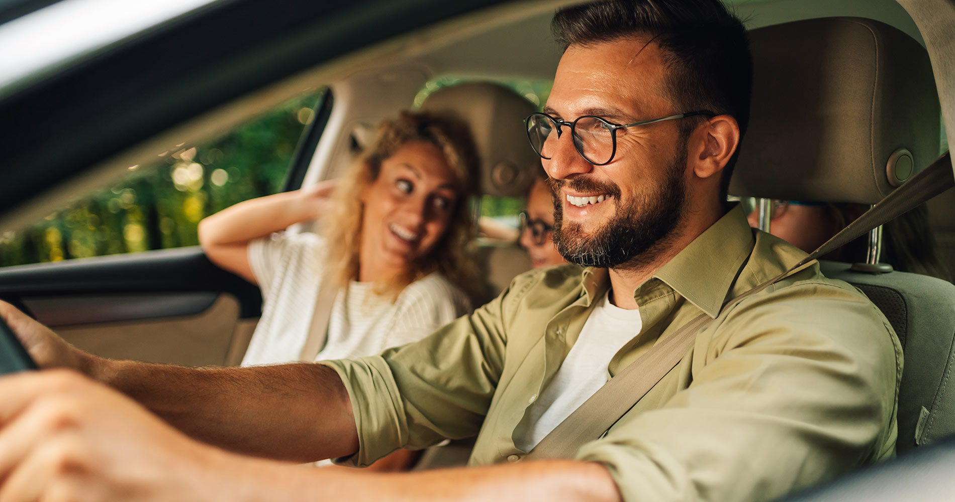 Young family driving home in their pre-owned vehicle
